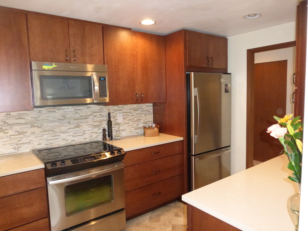 This is an example of a small contemporary galley enclosed kitchen in Seattle with a submerged sink, flat-panel cabinets, medium wood cabinets, engineered stone countertops, multi-coloured splashback, stainless steel appliances, vinyl flooring and no island.