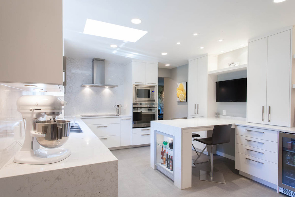 This is an example of a contemporary kitchen in Vancouver with stainless steel appliances.