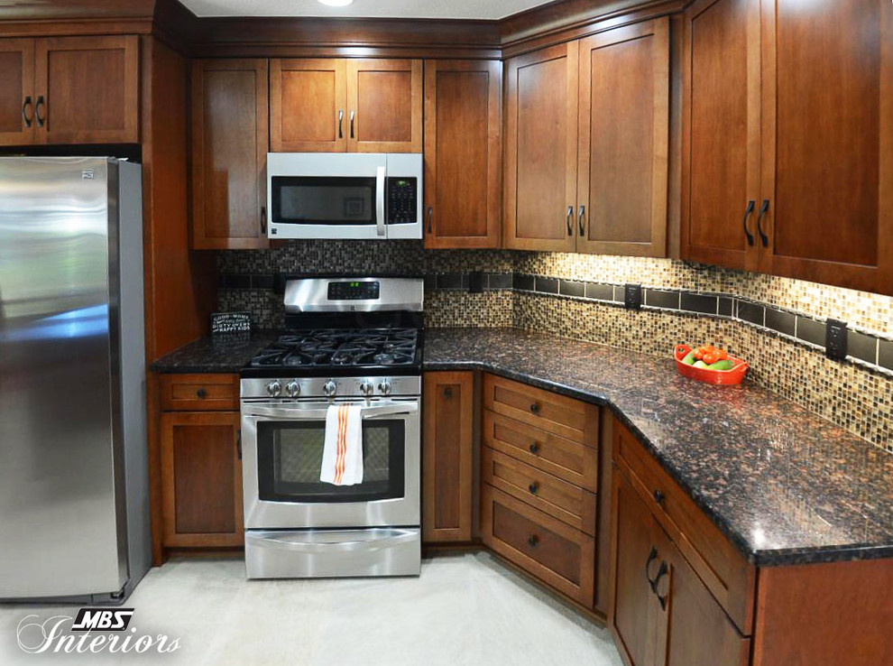 Inspiration for a mid-sized timeless kitchen remodel in Columbus with an undermount sink, shaker cabinets, medium tone wood cabinets, granite countertops, multicolored backsplash, stainless steel appliances and a peninsula
