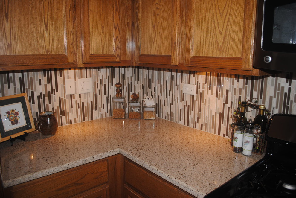 Updated quartz countertops and modern glass tile backsplashes