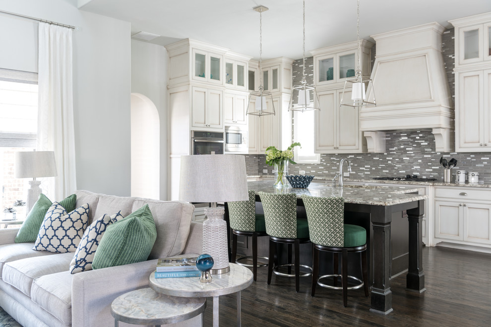 Inspiration for a mid-sized timeless l-shaped dark wood floor and brown floor open concept kitchen remodel in Dallas with recessed-panel cabinets, white cabinets, gray backsplash, an island, an undermount sink, granite countertops, matchstick tile backsplash and stainless steel appliances