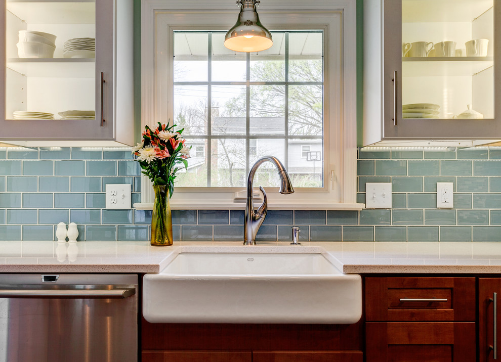 Example of a large trendy u-shaped eat-in kitchen design in Columbus with a farmhouse sink, shaker cabinets, white cabinets, granite countertops, gray backsplash, subway tile backsplash, stainless steel appliances and an island