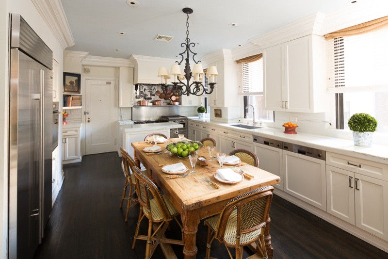 Example of a large eclectic dark wood floor eat-in kitchen design in New York with white cabinets, marble countertops, white backsplash, stone slab backsplash, paneled appliances, an island, recessed-panel cabinets and an undermount sink