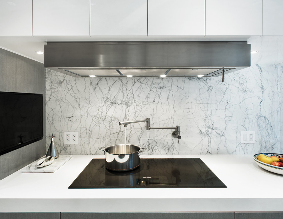 Enclosed kitchen - small modern galley porcelain tile and gray floor enclosed kitchen idea in New York with an undermount sink, flat-panel cabinets, gray cabinets, quartz countertops, white backsplash, marble backsplash, stainless steel appliances and white countertops
