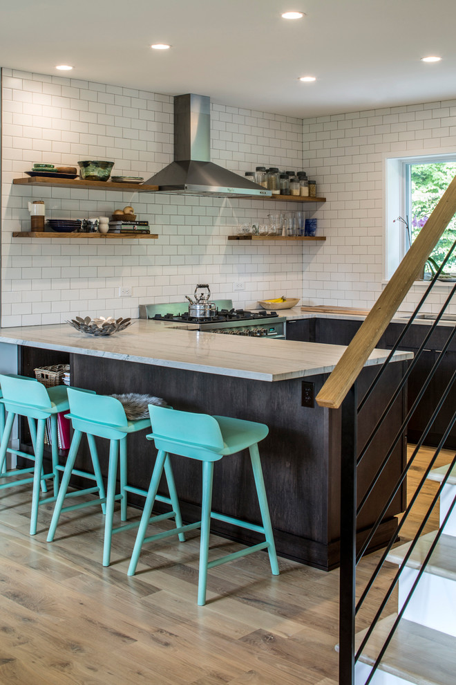 Eat-in kitchen - small contemporary u-shaped light wood floor eat-in kitchen idea in Other with an undermount sink, flat-panel cabinets, dark wood cabinets, quartzite countertops, white backsplash, subway tile backsplash, stainless steel appliances and a peninsula