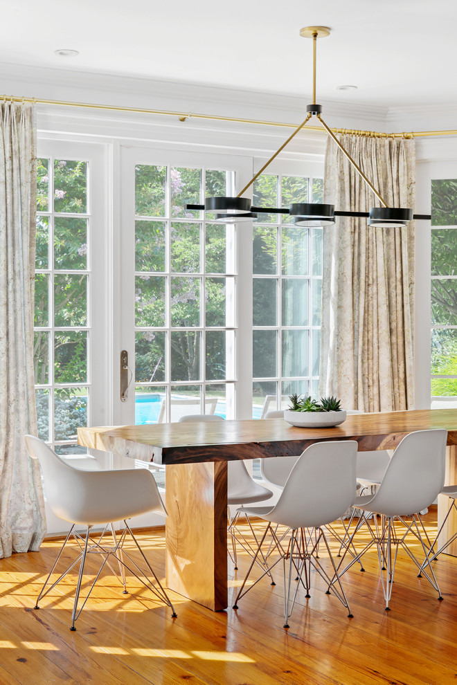 Example of a mid-sized minimalist medium tone wood floor enclosed dining room design in New York