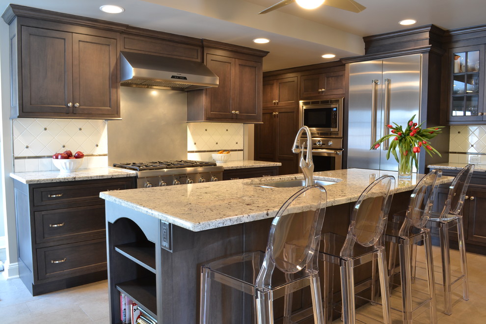 Mid-sized elegant l-shaped ceramic tile enclosed kitchen photo in New York with a double-bowl sink, beaded inset cabinets, gray cabinets, granite countertops, white backsplash, ceramic backsplash, stainless steel appliances and an island