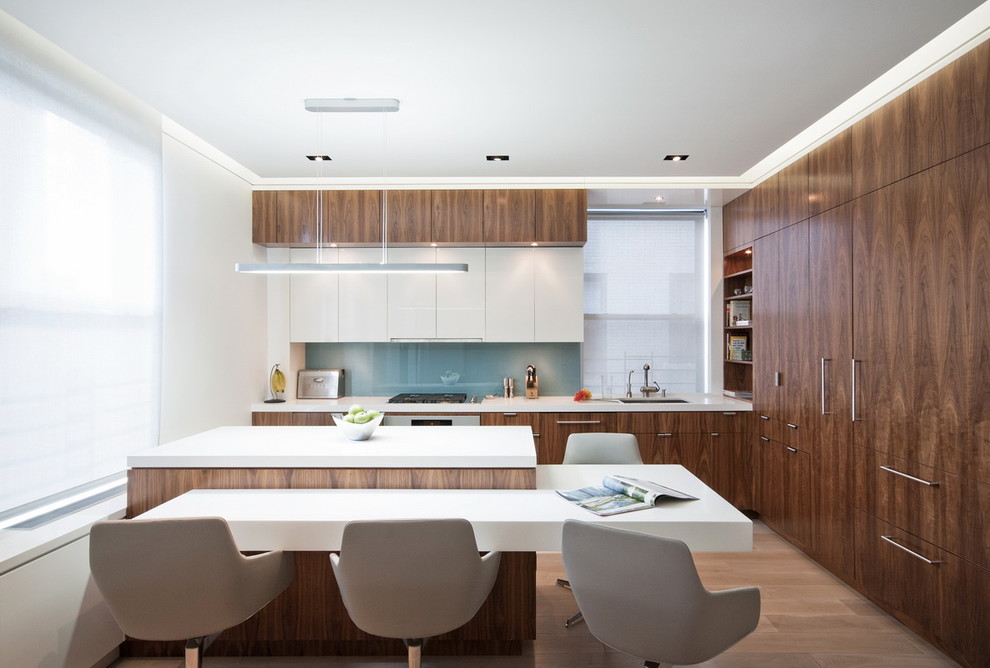 Design ideas for a modern l-shaped kitchen in New York with flat-panel cabinets, dark wood cabinets, engineered stone countertops, blue splashback, integrated appliances and glass sheet splashback.
