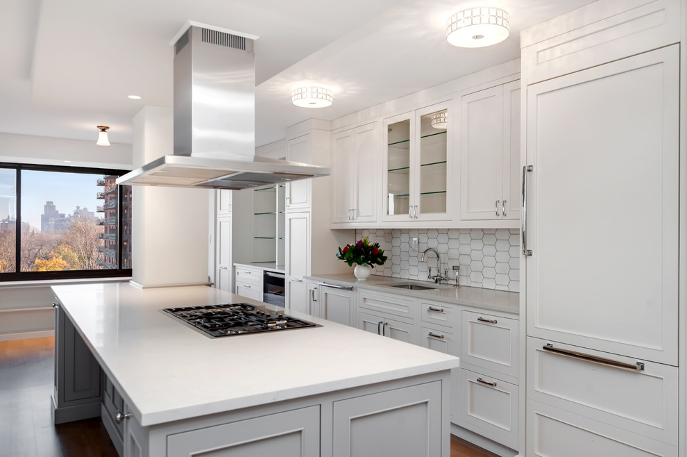 Eat-in kitchen - small traditional galley medium tone wood floor eat-in kitchen idea in New York with an undermount sink, beaded inset cabinets, white cabinets, quartz countertops, white backsplash, stone tile backsplash, paneled appliances and an island