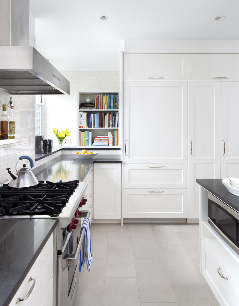 Example of a trendy kitchen design in New York with paneled appliances, subway tile backsplash and quartz countertops