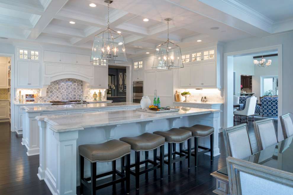 Inspiration for a mid-sized contemporary u-shaped dark wood floor enclosed kitchen remodel in Los Angeles with an undermount sink, shaker cabinets, white cabinets, granite countertops, multicolored backsplash, subway tile backsplash, stainless steel appliances and two islands