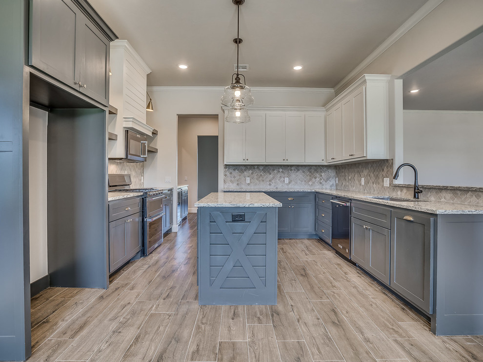 Eat-in kitchen - huge country u-shaped light wood floor eat-in kitchen idea in Oklahoma City with an undermount sink, shaker cabinets, gray cabinets, granite countertops, multicolored backsplash, marble backsplash, stainless steel appliances, an island and multicolored countertops