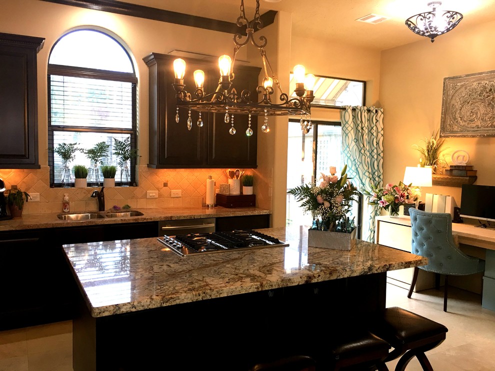 Enclosed kitchen - mid-sized traditional single-wall marble floor and beige floor enclosed kitchen idea in Phoenix with a double-bowl sink, raised-panel cabinets, dark wood cabinets, granite countertops, beige backsplash, stone tile backsplash, stainless steel appliances and an island
