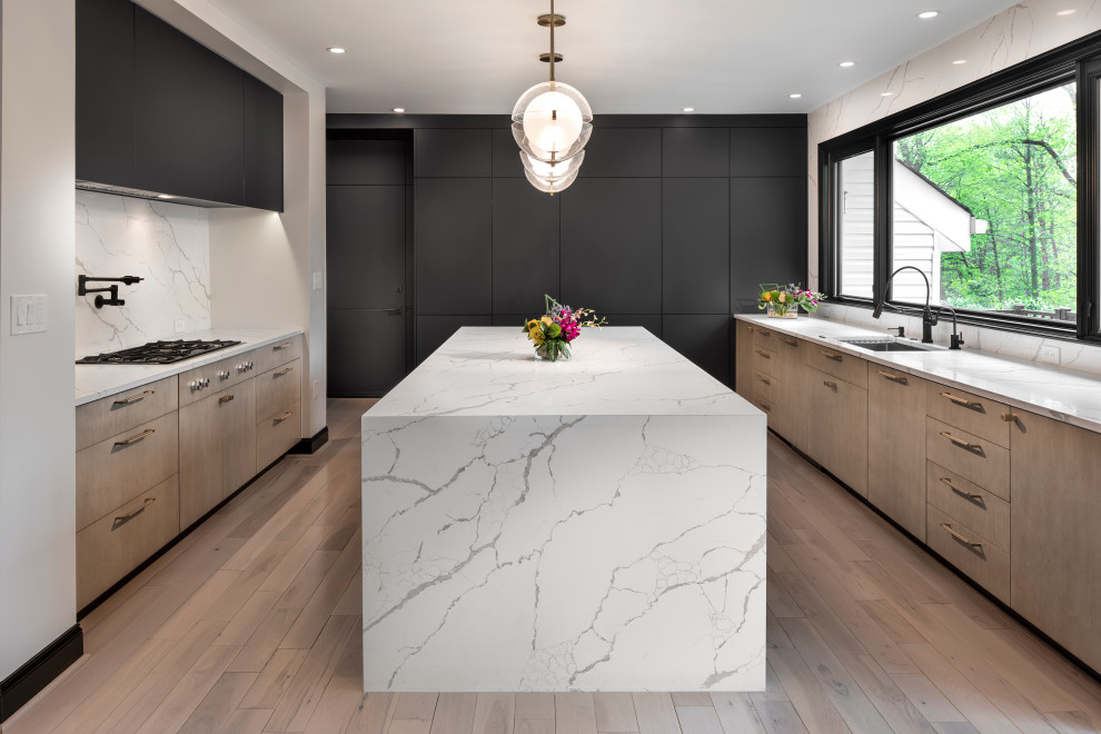 Inspiration for a contemporary u-shaped medium tone wood floor and brown floor enclosed kitchen remodel in DC Metro with an undermount sink, flat-panel cabinets, medium tone wood cabinets, quartz countertops, multicolored backsplash, paneled appliances, an island and multicolored countertops