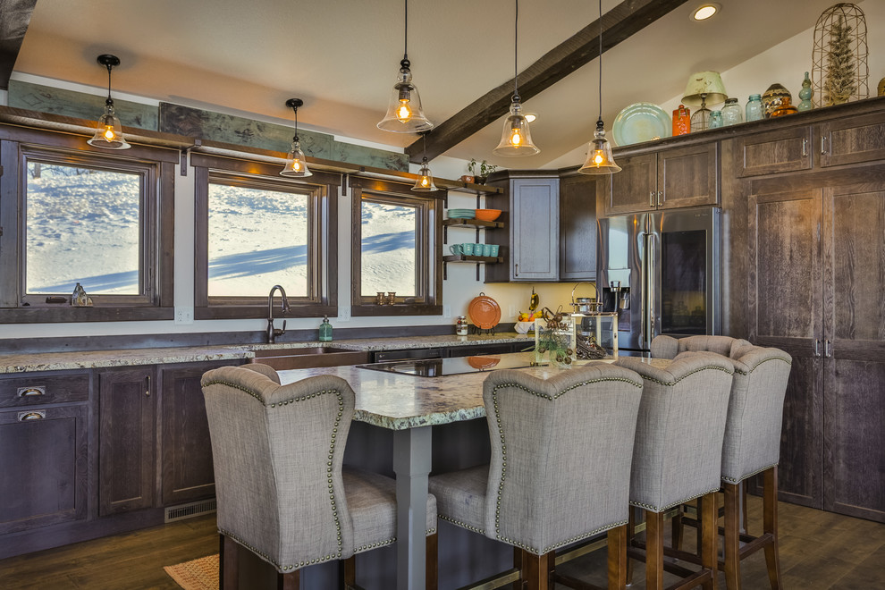 Mountain style l-shaped dark wood floor and brown floor kitchen photo in Other with a farmhouse sink, shaker cabinets, dark wood cabinets, window backsplash, stainless steel appliances and an island