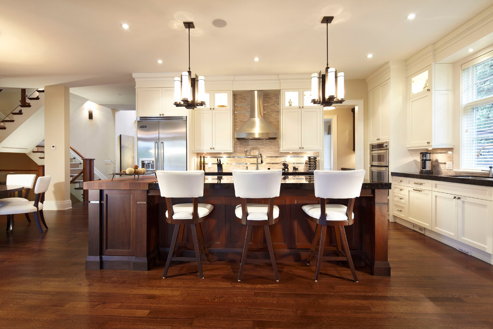 Large transitional l-shaped medium tone wood floor eat-in kitchen photo in Toronto with an undermount sink, shaker cabinets, white cabinets, stainless steel appliances, an island and multicolored backsplash