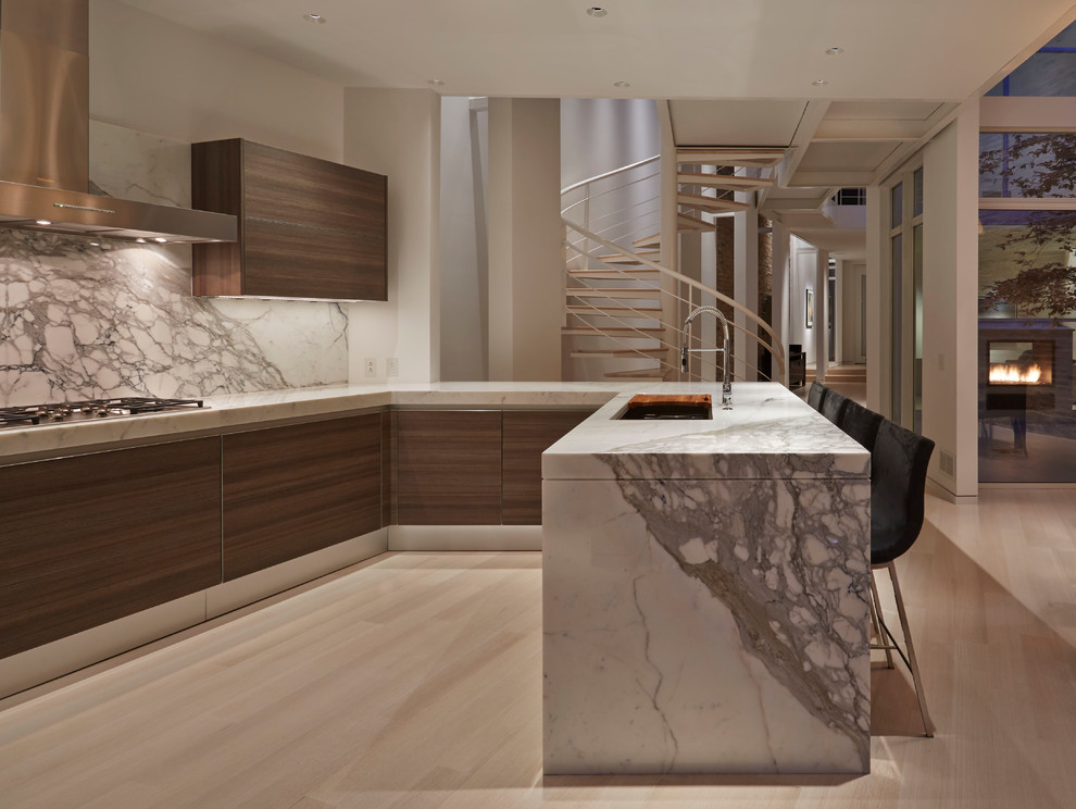 Photo of a contemporary u-shaped kitchen in Chicago with a submerged sink, stone slab splashback and a breakfast bar.