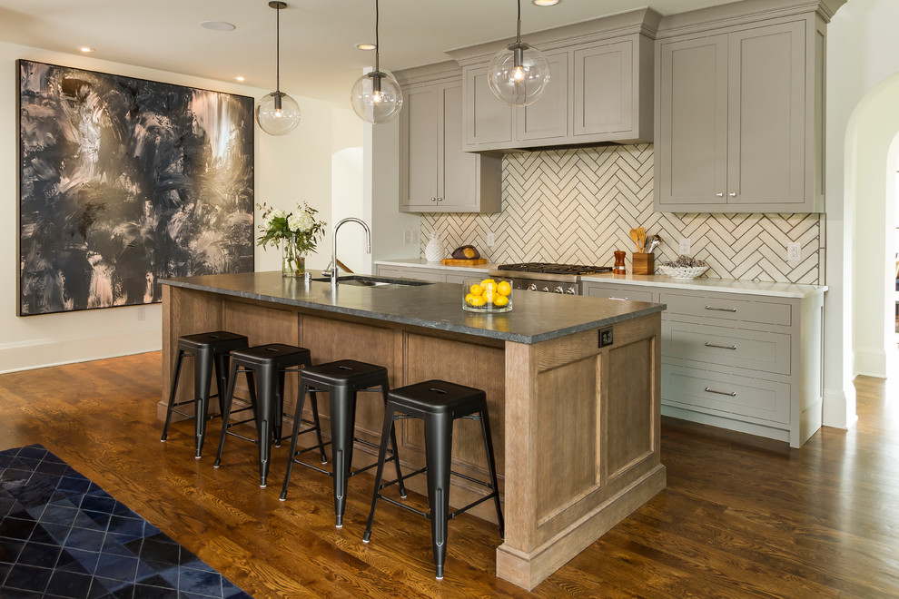 This is an example of a large classic kitchen/diner in Minneapolis with a submerged sink, shaker cabinets, beige splashback, integrated appliances, dark hardwood flooring, an island and brown floors.