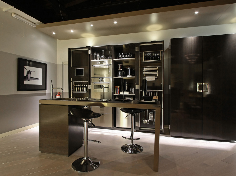 Photo of a contemporary galley kitchen in Other with stainless steel appliances, flat-panel cabinets and black cabinets.