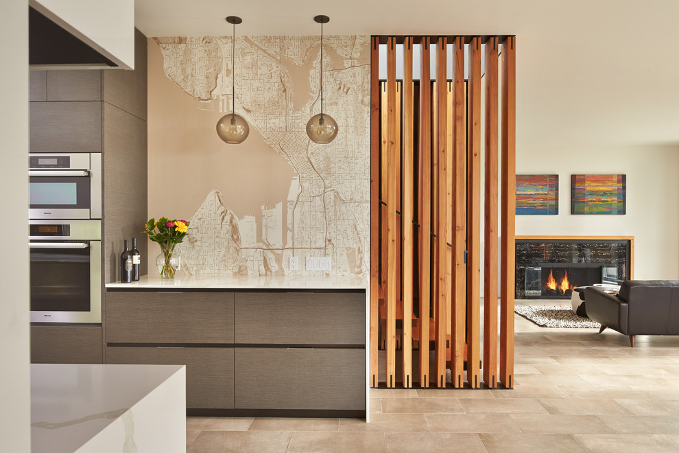 Inspiration for a contemporary galley kitchen in Seattle with flat-panel cabinets, dark wood cabinets, stainless steel appliances and a feature wall.
