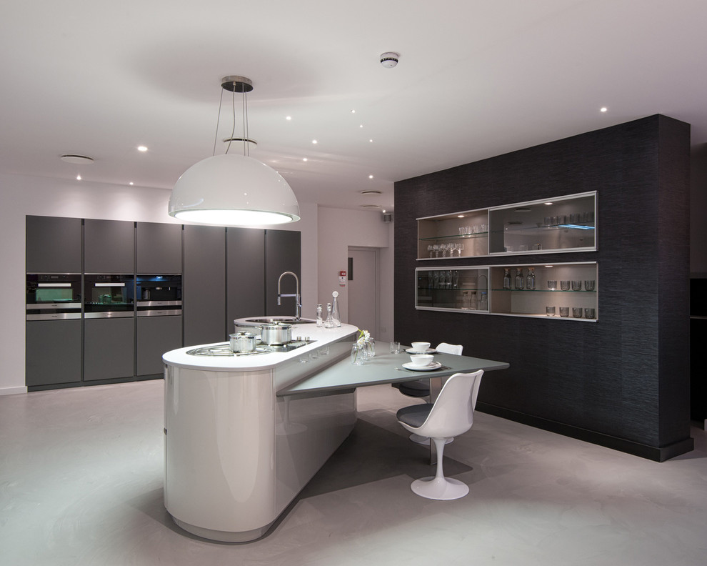 Inspiration for a large contemporary concrete floor kitchen remodel in London with an island, an undermount sink, flat-panel cabinets and gray cabinets