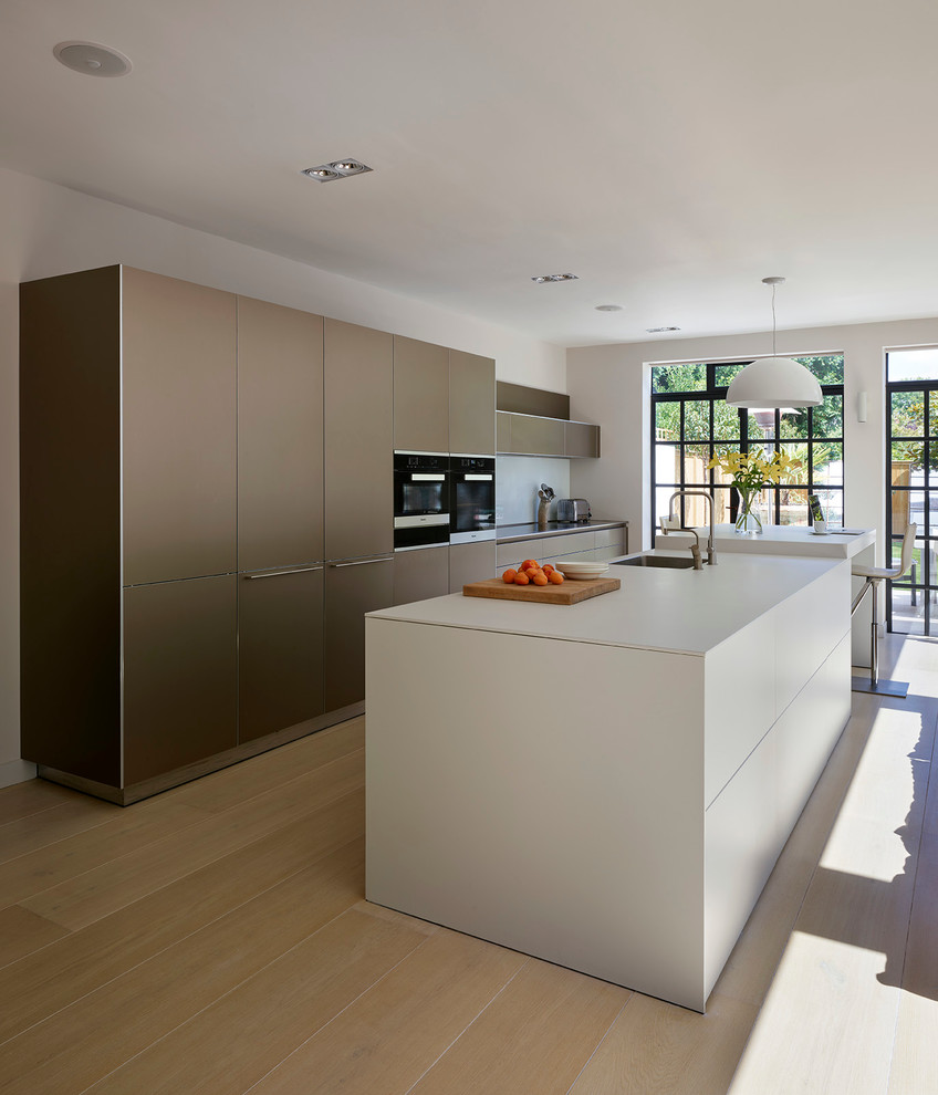 Inredning av ett modernt stort kök med öppen planlösning, med laminatbänkskiva och en köksö