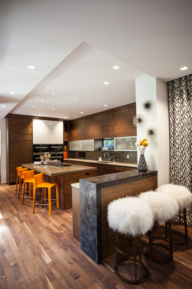 This is an example of a large modern u-shaped kitchen/diner in Denver with a submerged sink, flat-panel cabinets, dark wood cabinets, quartz worktops, brown splashback, ceramic splashback, integrated appliances, medium hardwood flooring and an island.