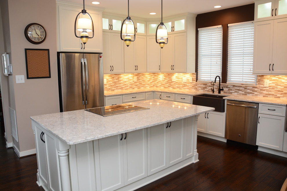 Design ideas for a large classic l-shaped kitchen/diner in DC Metro with a belfast sink, recessed-panel cabinets, white cabinets, engineered stone countertops, multi-coloured splashback, stainless steel appliances, dark hardwood flooring, an island and brown floors.