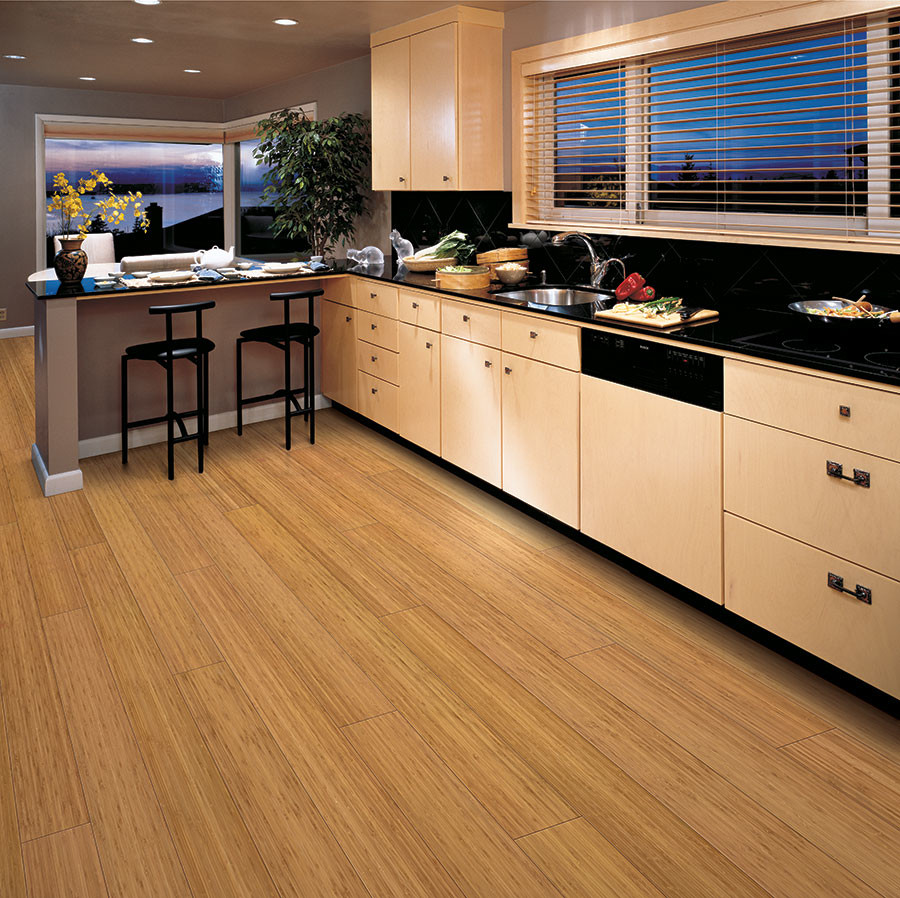 Mid-sized minimalist l-shaped bamboo floor eat-in kitchen photo in Chicago with a single-bowl sink, flat-panel cabinets, light wood cabinets, black backsplash and a peninsula