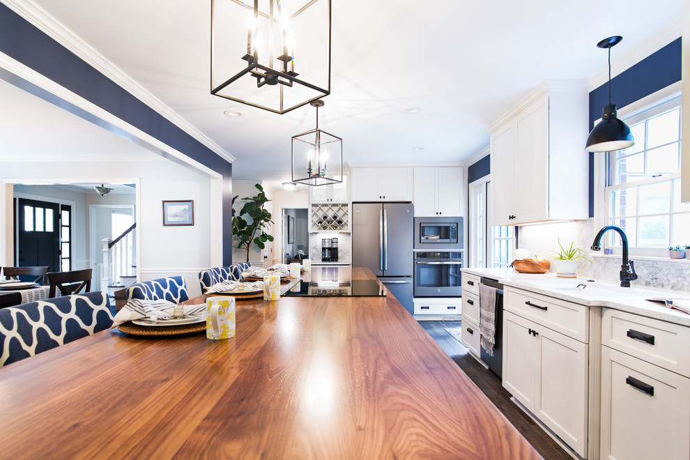 Inspiration for a mid-sized coastal galley dark wood floor and brown floor open concept kitchen remodel in Other with a single-bowl sink, flat-panel cabinets, quartz countertops, gray backsplash, marble backsplash, stainless steel appliances, an island and gray countertops