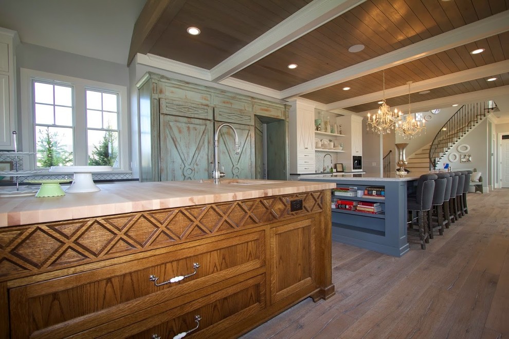 Eat-in kitchen - huge cottage galley light wood floor eat-in kitchen idea in Salt Lake City with a farmhouse sink, recessed-panel cabinets, medium tone wood cabinets, wood countertops, white backsplash, ceramic backsplash, stainless steel appliances and two islands