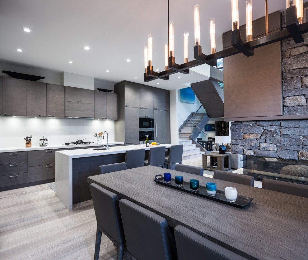 Design ideas for a large contemporary l-shaped kitchen/diner in Vancouver with a submerged sink, flat-panel cabinets, dark wood cabinets, quartz worktops, white splashback, stone slab splashback, integrated appliances, medium hardwood flooring, an island and grey floors.