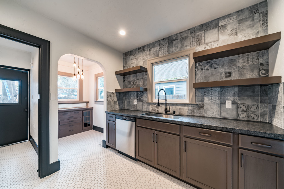 Enclosed kitchen - mid-sized industrial single-wall ceramic tile and white floor enclosed kitchen idea in Other with an undermount sink, recessed-panel cabinets, dark wood cabinets, granite countertops, gray backsplash, cement tile backsplash, stainless steel appliances and no island
