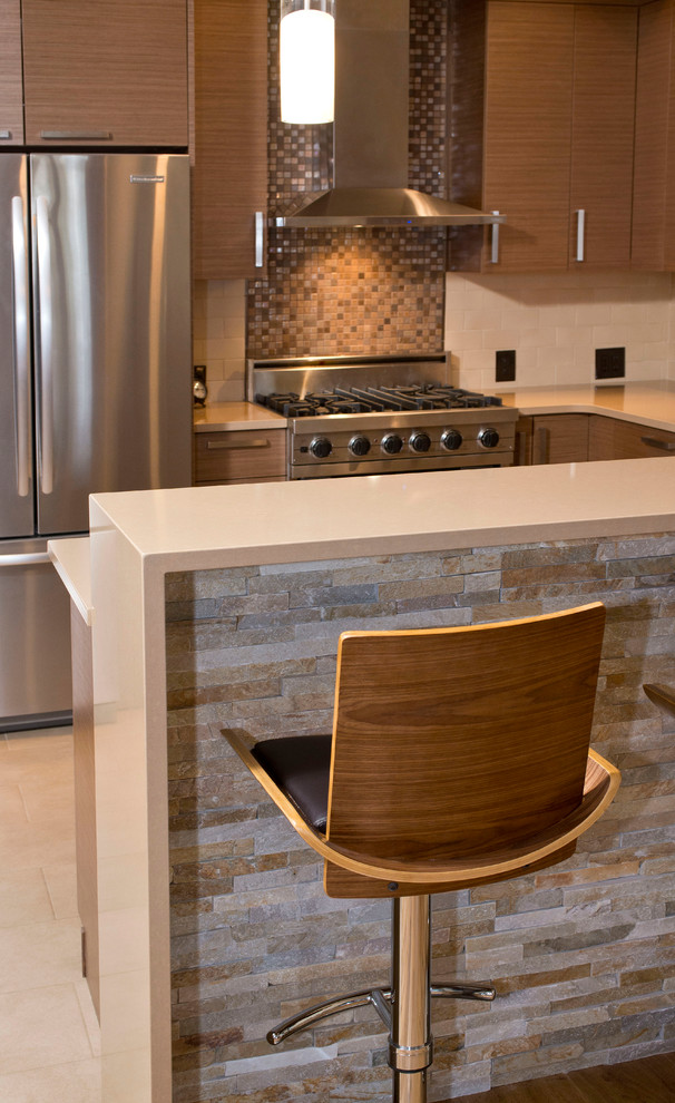 Medium sized contemporary u-shaped kitchen/diner in Denver with a submerged sink, flat-panel cabinets, medium wood cabinets, engineered stone countertops, beige splashback, glass tiled splashback, stainless steel appliances, ceramic flooring and a breakfast bar.