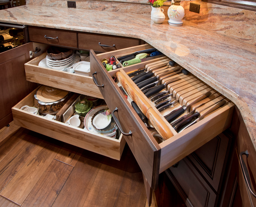 This is an example of a medium sized traditional u-shaped kitchen/diner in Denver with a submerged sink, recessed-panel cabinets, medium wood cabinets, granite worktops, beige splashback, stainless steel appliances and an island.