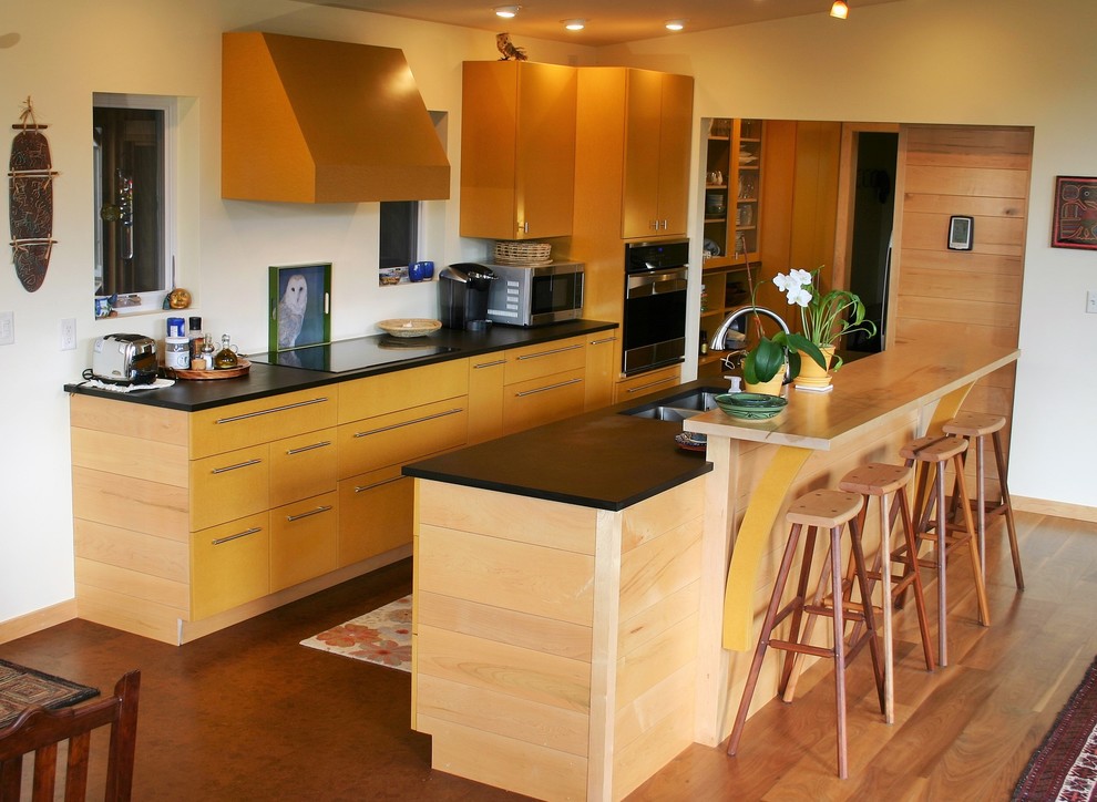 Photo of a medium sized contemporary galley kitchen pantry in Burlington with a submerged sink, flat-panel cabinets, yellow cabinets, composite countertops, stainless steel appliances, cork flooring, an island and brown floors.
