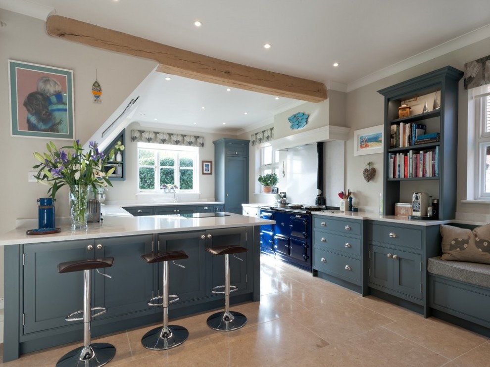 Design ideas for a large country u-shaped open plan kitchen in Kent with shaker cabinets, composite countertops, coloured appliances, blue cabinets, a breakfast bar, beige floors and white worktops.
