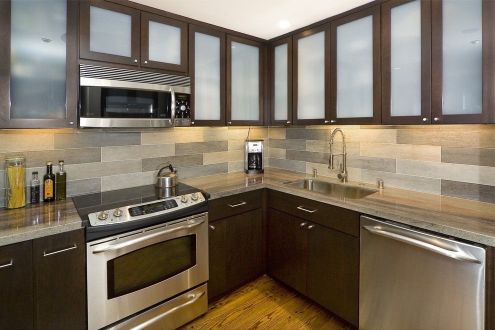 Inspiration for a contemporary kitchen remodel in San Francisco with glass-front cabinets and limestone backsplash