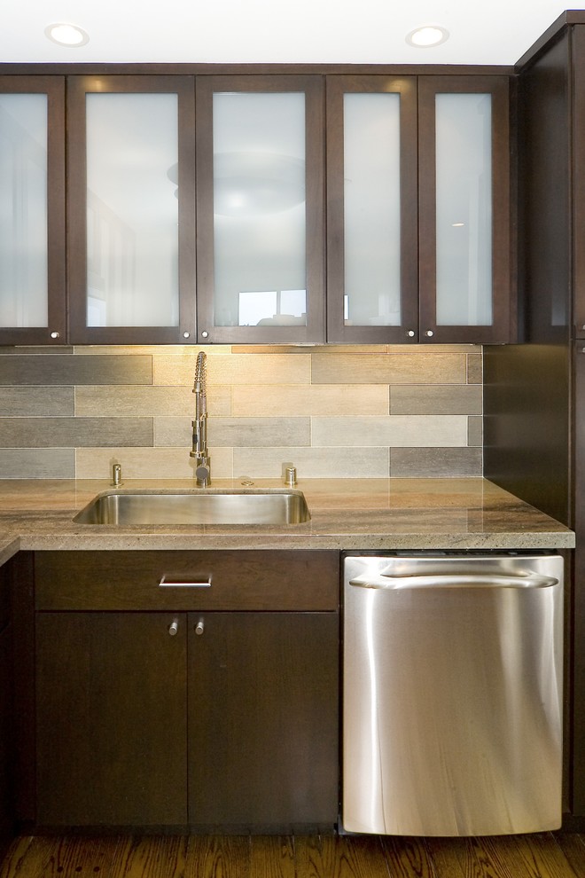 Example of a trendy kitchen design in San Francisco with granite countertops, glass-front cabinets, dark wood cabinets, gray backsplash, glass tile backsplash and stainless steel appliances