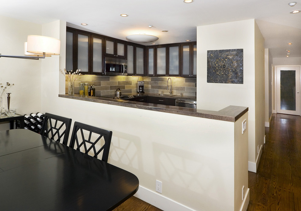 Trendy kitchen photo in San Francisco with glass-front cabinets and stainless steel appliances