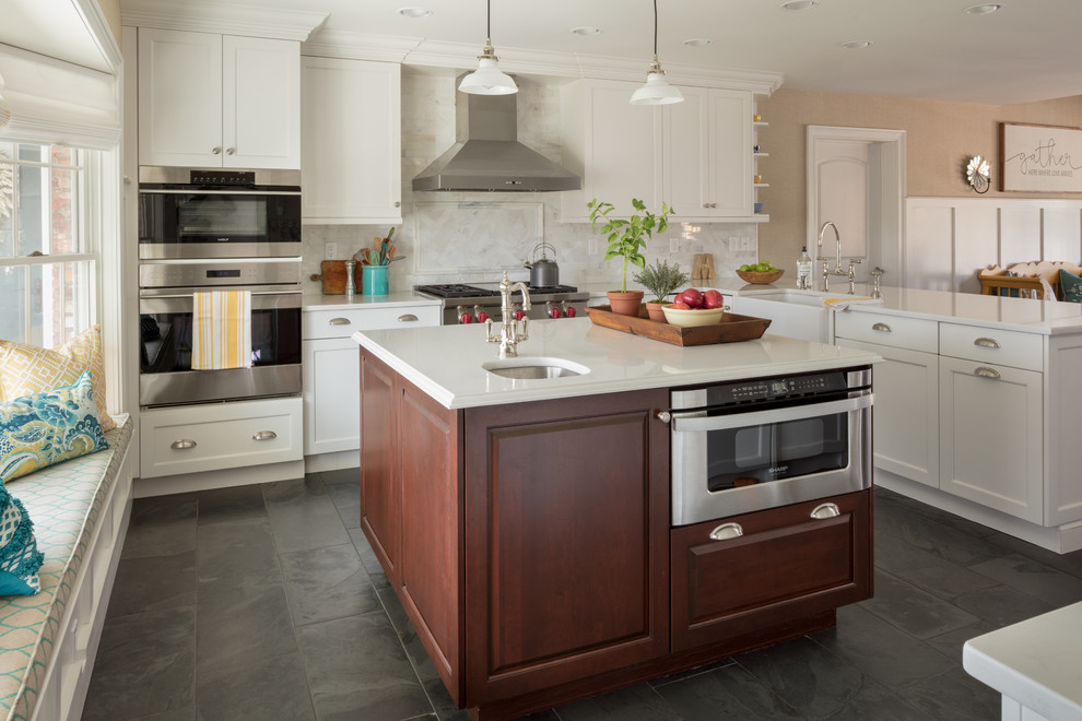 Inspiration for a mid-sized timeless l-shaped ceramic tile and gray floor open concept kitchen remodel in Other with a farmhouse sink, shaker cabinets, white cabinets, quartzite countertops, white backsplash, subway tile backsplash, stainless steel appliances and an island