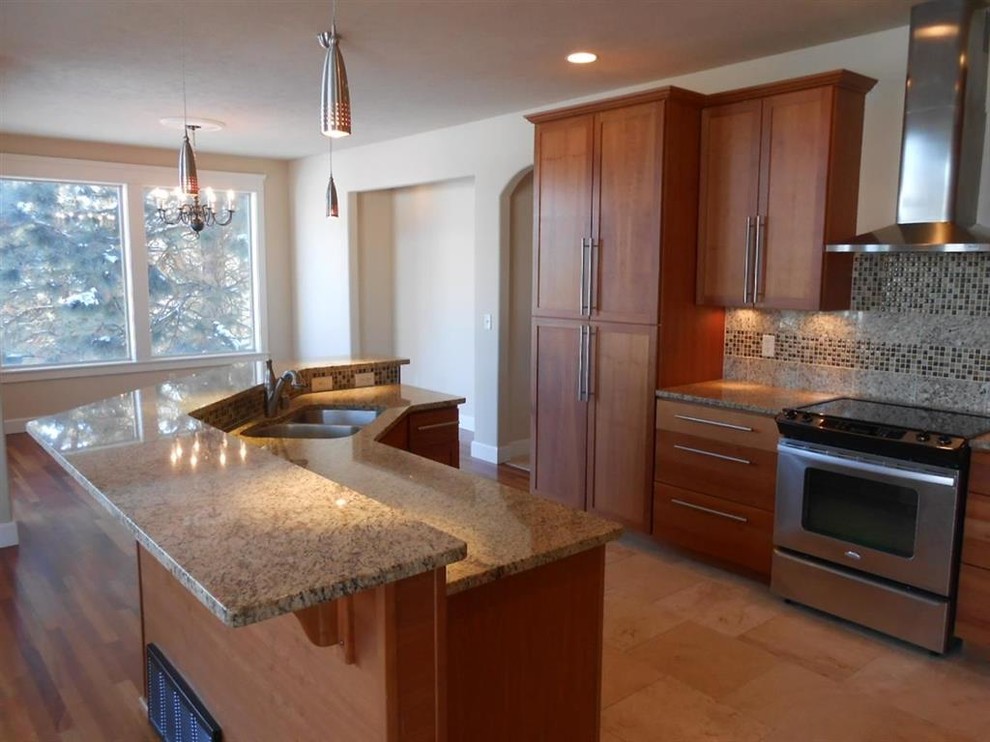 Mid-sized arts and crafts l-shaped marble floor open concept kitchen photo in Seattle with an undermount sink, shaker cabinets, light wood cabinets, granite countertops, beige backsplash, glass tile backsplash, stainless steel appliances and an island