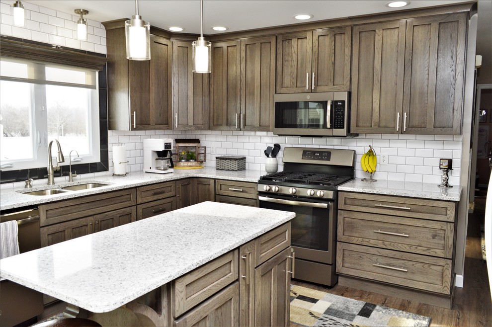 Example of a mid-sized cottage l-shaped eat-in kitchen design in Chicago with an undermount sink, shaker cabinets, gray cabinets, quartzite countertops, white backsplash, subway tile backsplash, an island and gray countertops