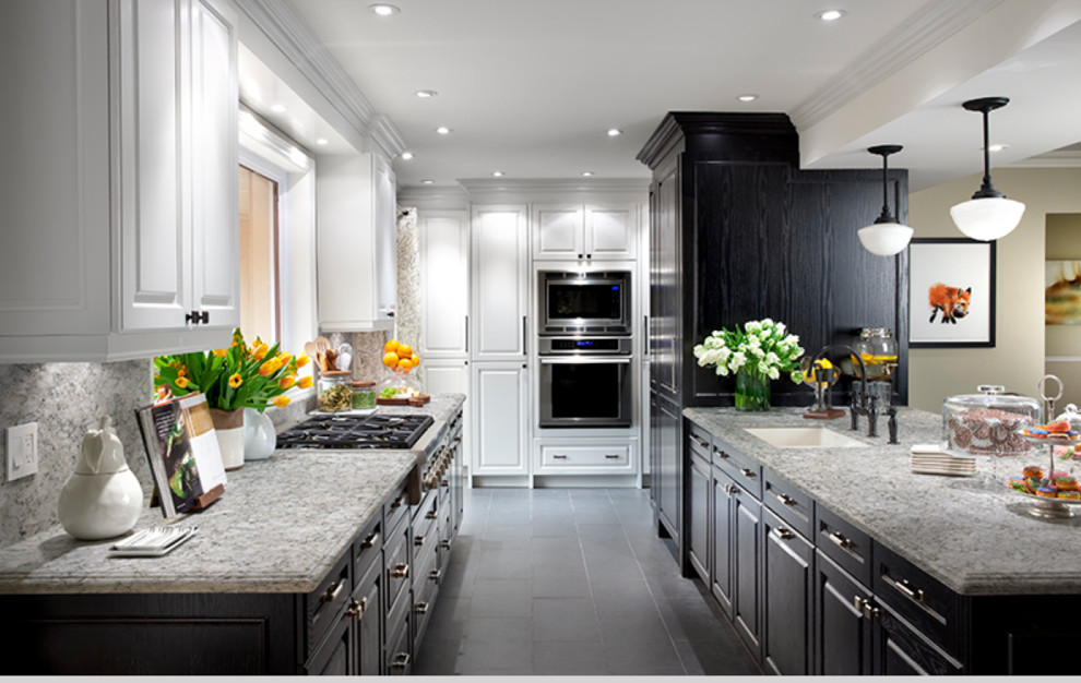 Inspiration for a large classic galley kitchen/diner in New York with a submerged sink, raised-panel cabinets, dark wood cabinets, granite worktops, multi-coloured splashback, stone slab splashback, stainless steel appliances, cement flooring, an island, grey floors and grey worktops.