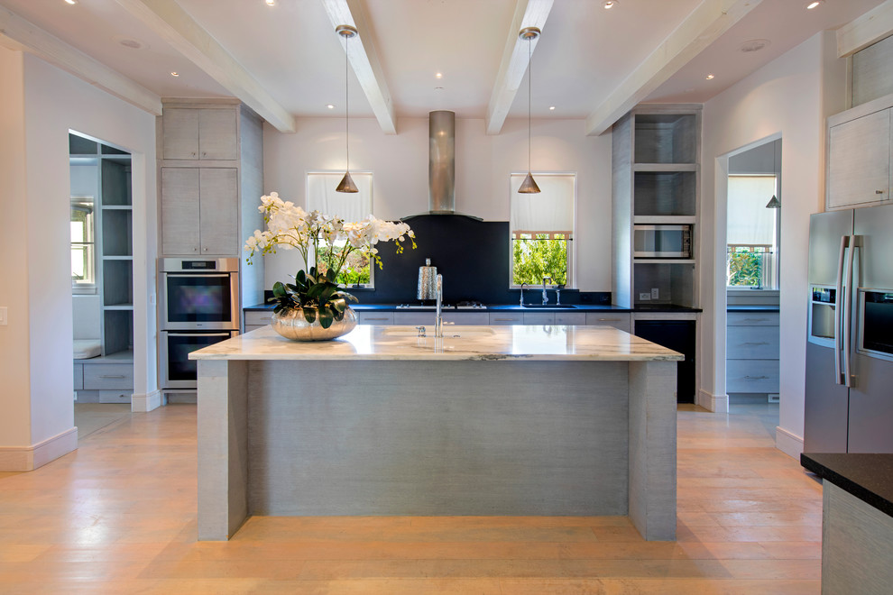 Inspiration for a large modern u-shaped light wood floor open concept kitchen remodel in Dallas with flat-panel cabinets, an island, a double-bowl sink, distressed cabinets, marble countertops, black backsplash, stone slab backsplash and stainless steel appliances