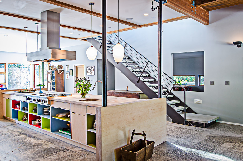 This is an example of an urban kitchen in Seattle with wood worktops and open cabinets.