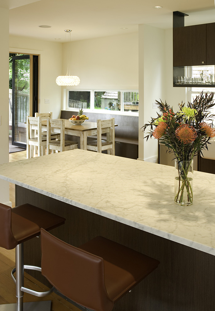 Trendy kitchen photo in Seattle with flat-panel cabinets, dark wood cabinets and marble countertops