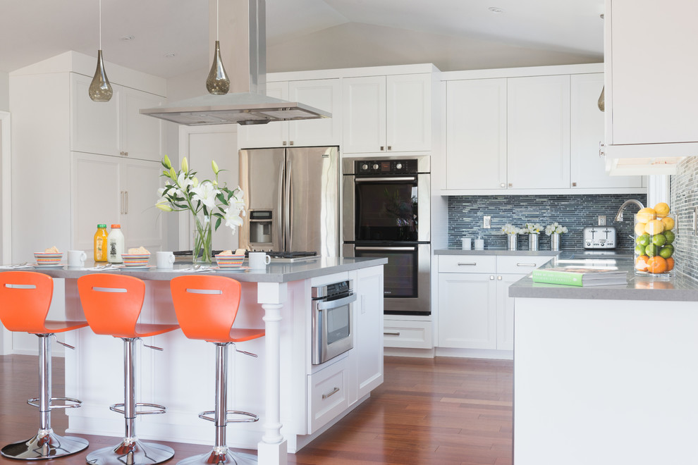 Example of a transitional l-shaped open concept kitchen design in San Francisco with an undermount sink, shaker cabinets, white cabinets, quartz countertops, multicolored backsplash, mosaic tile backsplash and stainless steel appliances