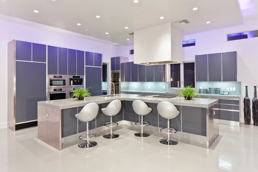 Ejemplo de cocinas en L actual con armarios con paneles lisos, puertas de armario grises y electrodomésticos con paneles