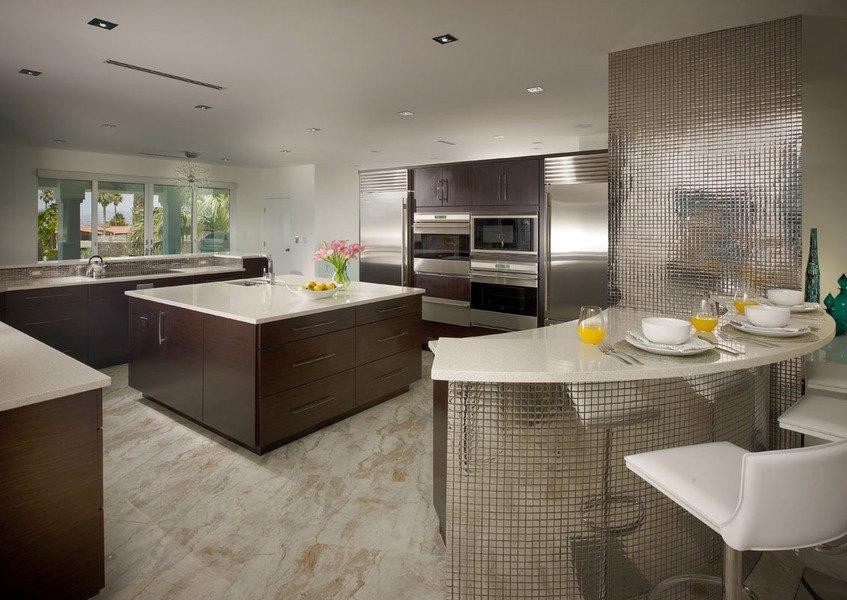 Inspiration for a large contemporary l-shaped marble floor and beige floor enclosed kitchen remodel in Las Vegas with an undermount sink, flat-panel cabinets, dark wood cabinets, quartz countertops, metallic backsplash, metal backsplash, stainless steel appliances and an island